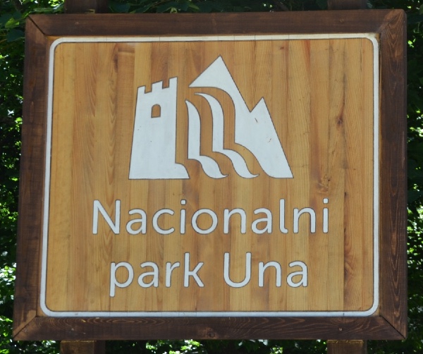 the Una NP logo: castles, waterfalls and mountains